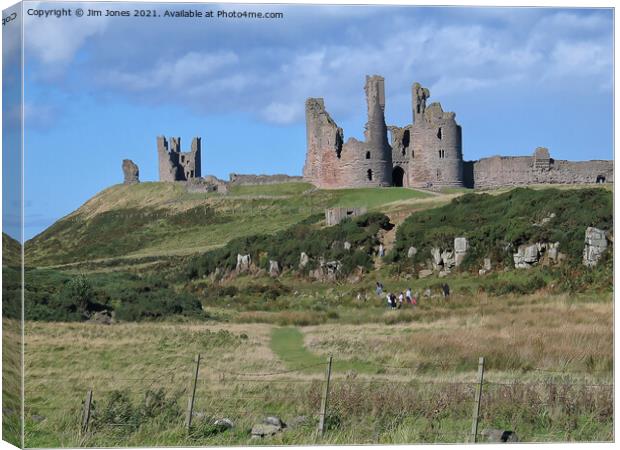 Majestic Ruins of Dunstanburgh Castle in Northumbe Canvas Print by Jim Jones