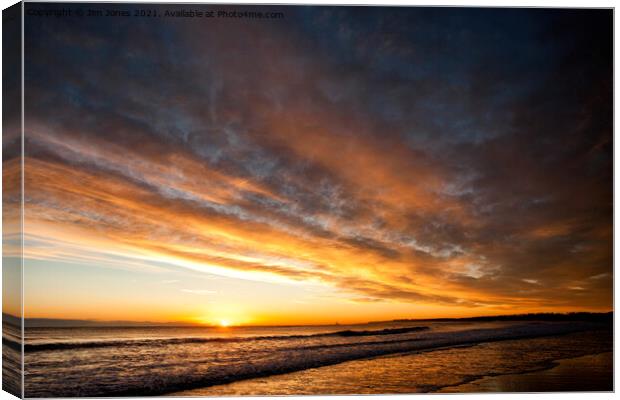 Morning sun sitting on the horizon Canvas Print by Jim Jones