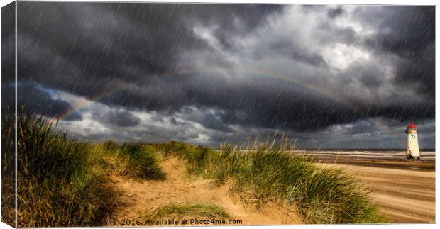 Lighthouse Rainbow Canvas Print by Adrian Evans