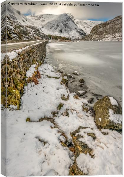 Icy Ogwen Lake Snowdonia Canvas Print by Adrian Evans