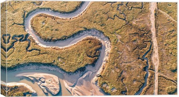 A lone rowing boat on the meandering creeks of Burnham Deepdale Canvas Print by Gary Pearson