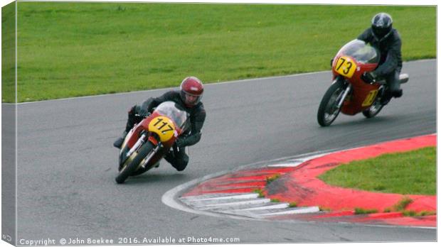 Racing bikes at Snetterton racetrack  Canvas Print by John Boekee