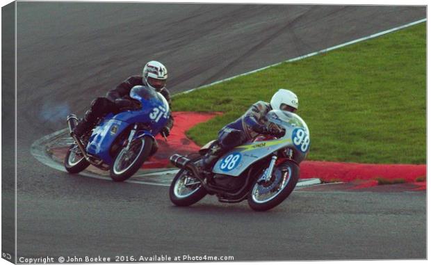 Racing bikes at Snetterton racetrack  Canvas Print by John Boekee