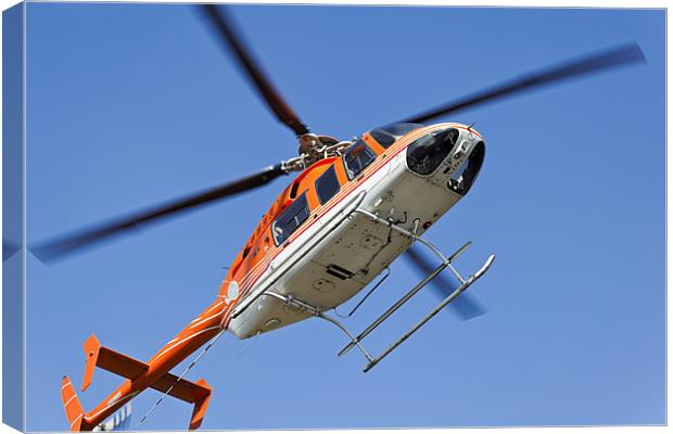 Hovering to land Orange White Helicopter Canvas Print by Arfabita  