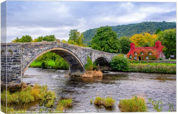 Llanrwst Stone Bridge and the  Tu Hwnt I'r Bont Tea Rooms. Canvas Print by Mike Shields