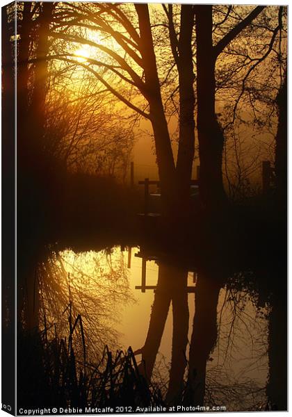 Sunrise with reflections Canvas Print by Debbie Metcalfe