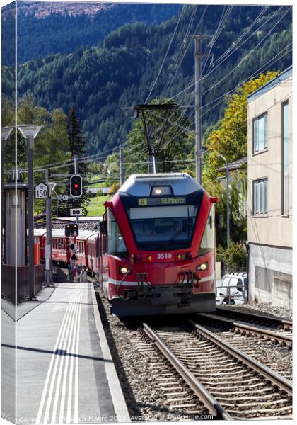 Train approaching Poschiavo station Canvas Print by Graham Moore
