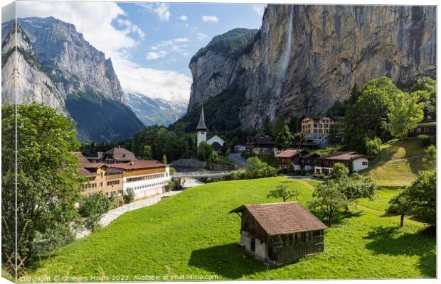 Lauterbrunnen village and Staubbach falls Canvas Print by Graham Moore