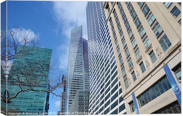 Manhattan Skyline From The Street Canvas Print by Malcolm Snook