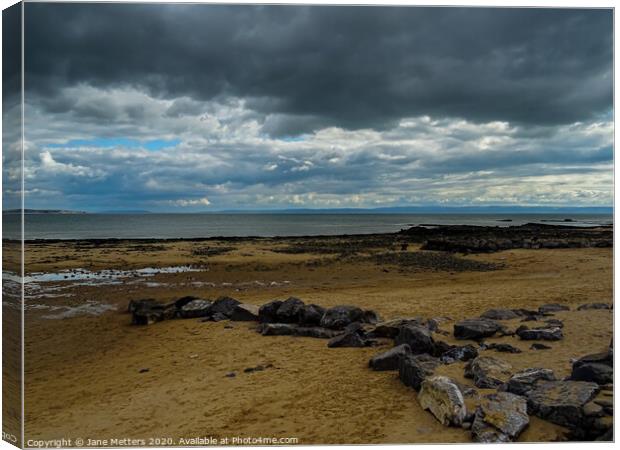 Rocks, Sand, Clouds and Sea Canvas Print by Jane Metters