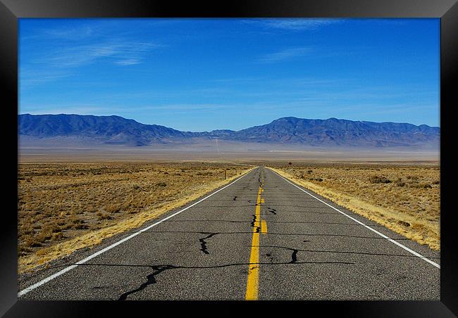 Highway through vast empty spaces, Nevada Framed Print by Claudio Del Luongo
