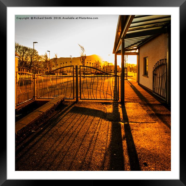Bright early morning sunlight through gates Framed Mounted Print by Richard Smith