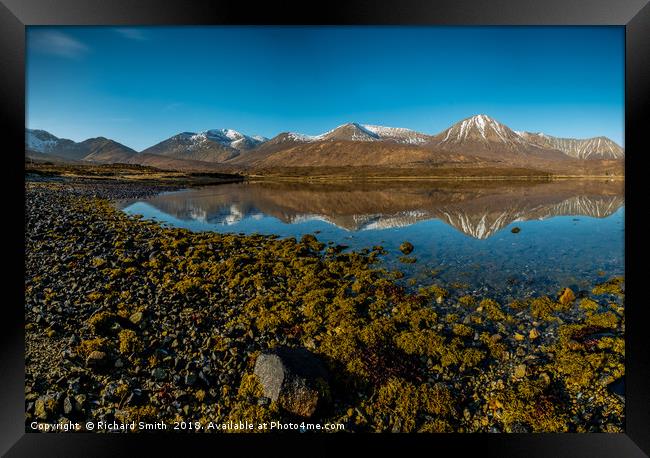 Snow capped Red Cuillin hills reflected. Framed Print by Richard Smith