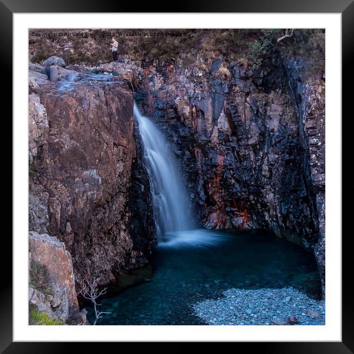 A hillwalker above a waterfall at the Fairy Pools Framed Mounted Print by Richard Smith