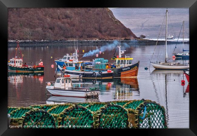 Fishermen at work in Portree harbour photographed from behind a stack of creels. Framed Print by Richard Smith