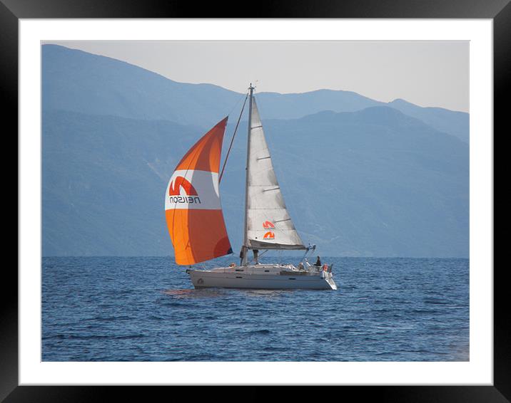 Youht with orange sail Framed Mounted Print by Rodney Leith