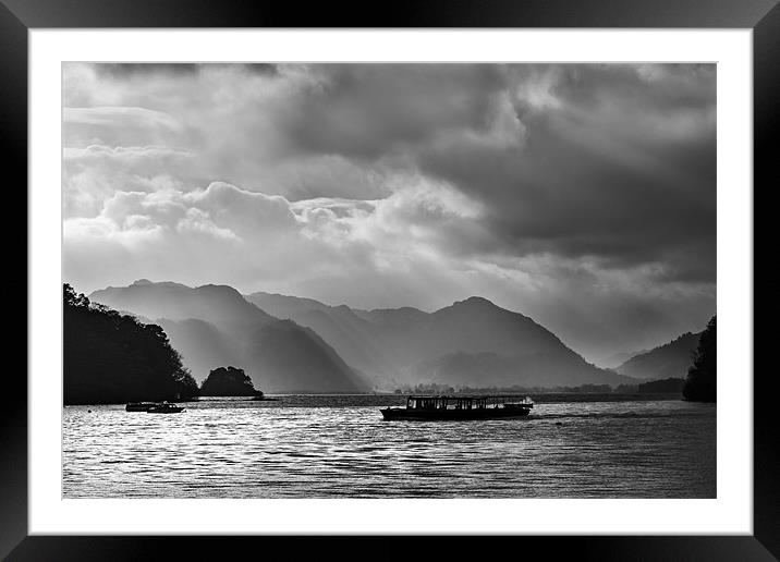 Crossing Derwentwater under stormy skies Framed Mounted Print by Ian Duffield