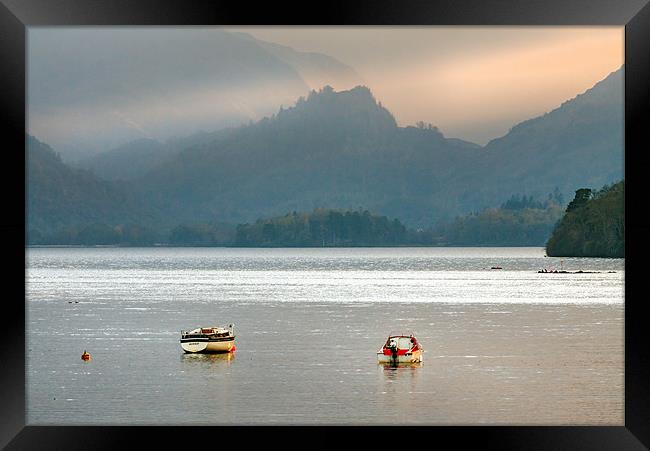 Caught in the light on Derwentwater. Framed Print by Ian Duffield