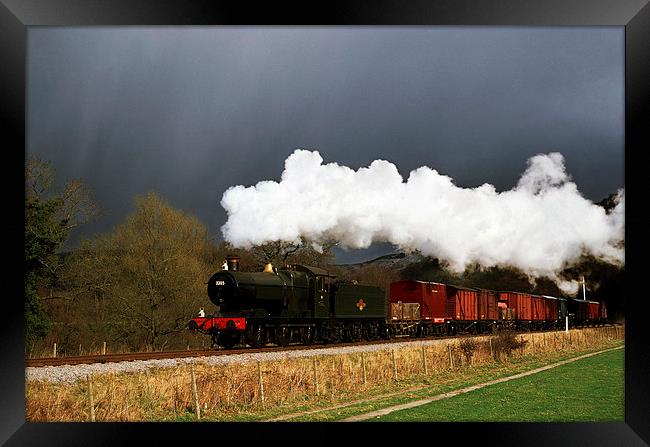 Goods train running ahead of a snowstorm  Framed Print by Ian Duffield