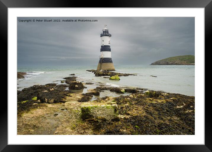 Penmon lighthouse sits at the start of the Menai Strait across f Framed Mounted Print by Peter Stuart