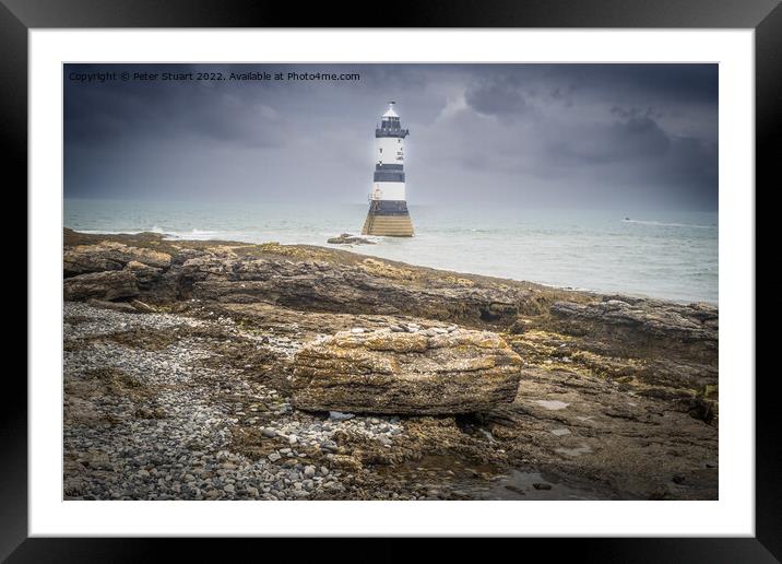 Penmon lighthouse sits at the start of the Menai Strait across f Framed Mounted Print by Peter Stuart
