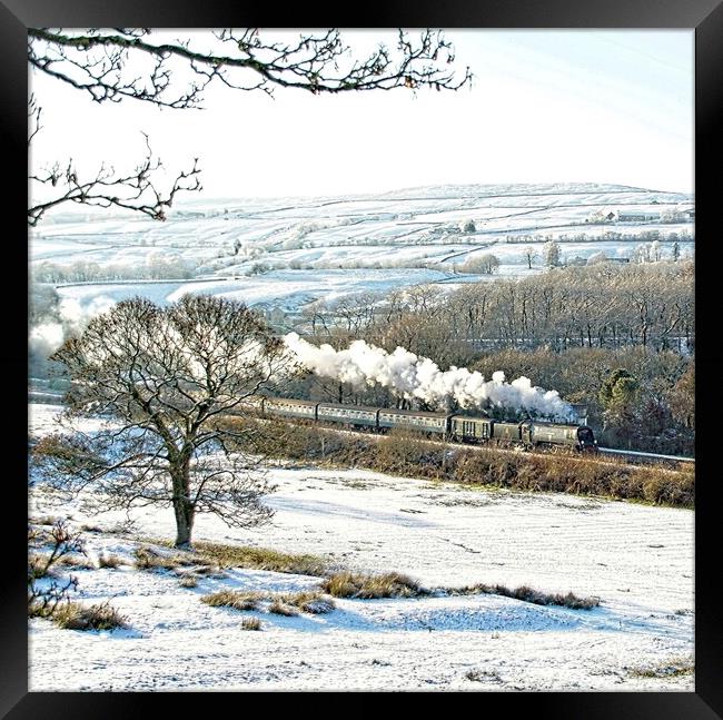Steam train in a snowy landscape. Framed Print by David Birchall