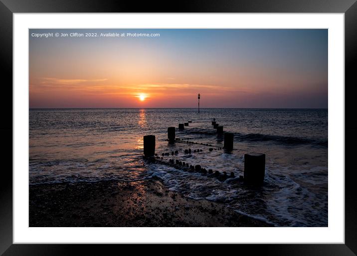 A sunset over a body of water Framed Mounted Print by Jon Clifton