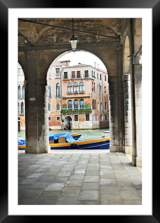 Venice Boat through Arches Framed Mounted Print by Jean Gill