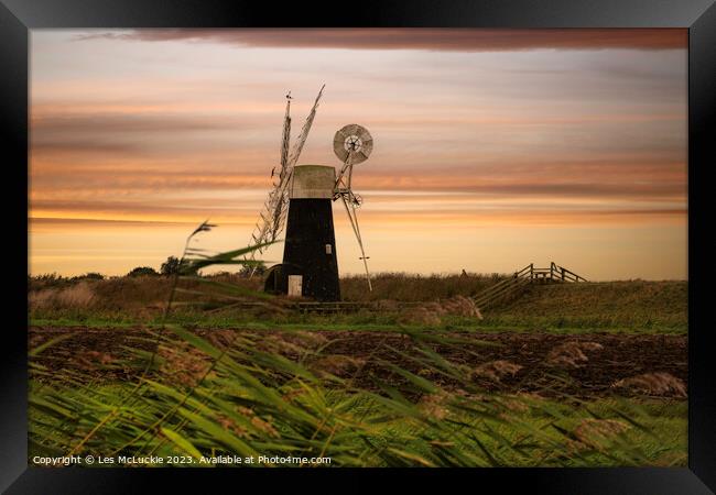 Windmill through the tall grass Framed Print by Les McLuckie