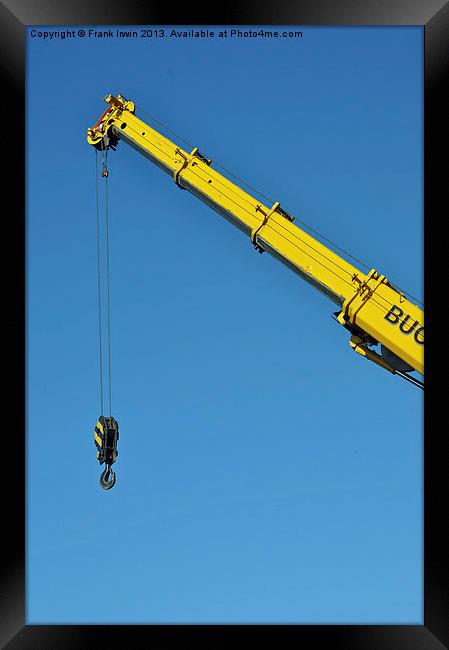 A bright yellow crane jib set against a clear blue Framed Print by Frank Irwin