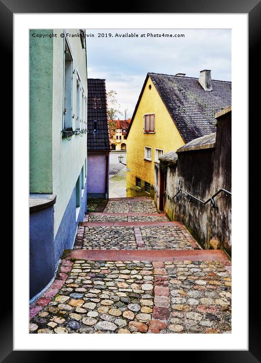 A quiet rising path between properties in Breisach Framed Mounted Print by Frank Irwin
