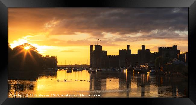 The setting sun at Caernarfon Castle Wales Framed Print by Chris Warren