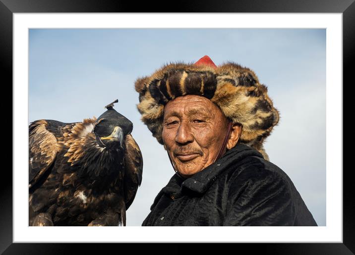 A man holding a bird Framed Mounted Print by Andrew chittock