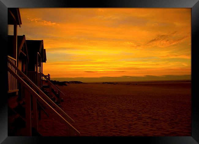 Sunset on the beach huts Framed Print by Colin Brittain