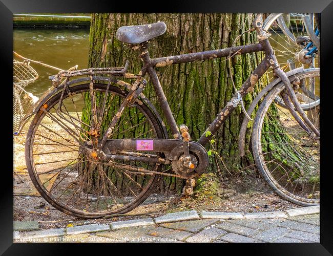 Abandoned bike on an Amsterdam canal-side Framed Print by Paul Nicholas