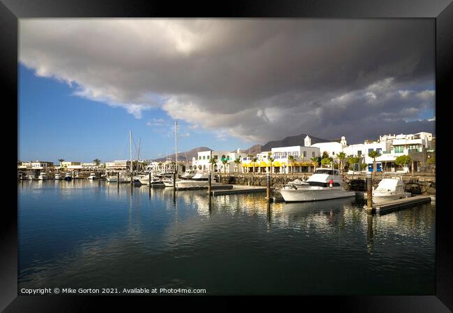 Storm clouds over Playa Blanca Marina Lanzarote Framed Print by Mike Gorton