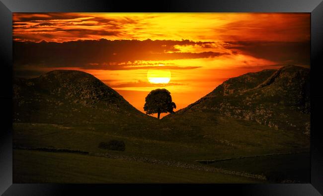 sunset behind the silhouette of Sycamore Gap Framed Print by Guido Parmiggiani