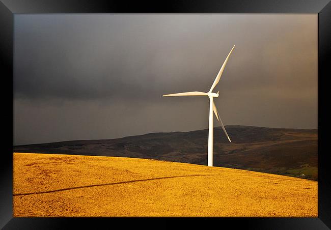  Wind Turbine standing tall in the evening sunligh Framed Print by Spenser Davies