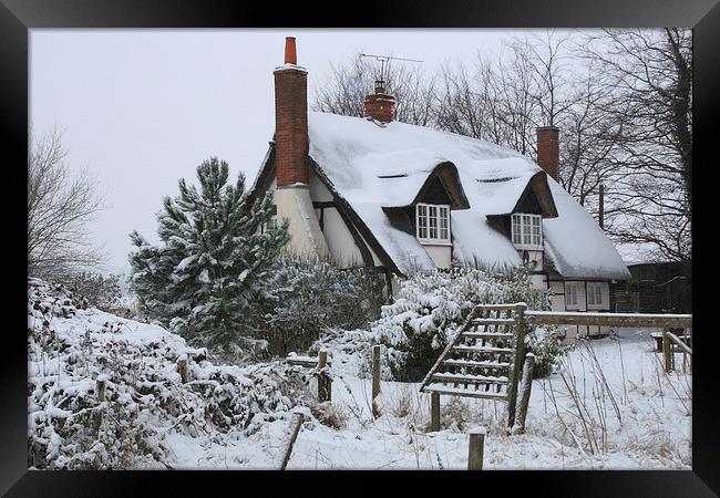 The Cottage in the Snow Framed Print by Ceri Jones