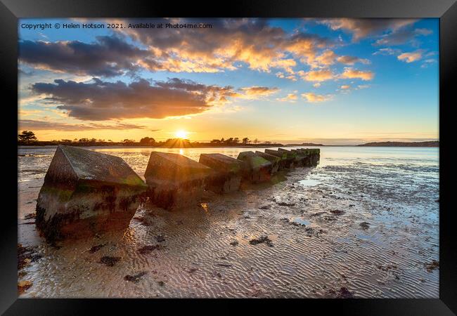 Beautiful sunset over old WWII tank traps in Bramble Bush Bay  Framed Print by Helen Hotson