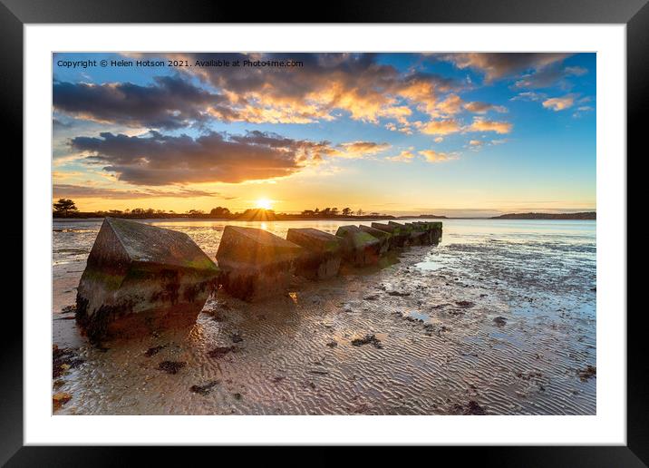 Beautiful sunset over old WWII tank traps in Bramble Bush Bay  Framed Mounted Print by Helen Hotson