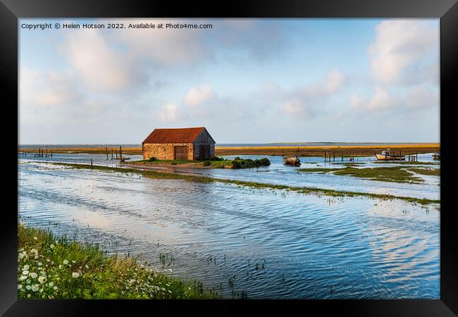 Spring tides flooding the old harbour at Thornham  Framed Print by Helen Hotson