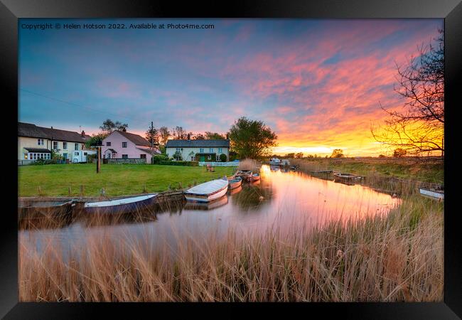 Stunning sunset over the village green and boats on the river at Framed Print by Helen Hotson