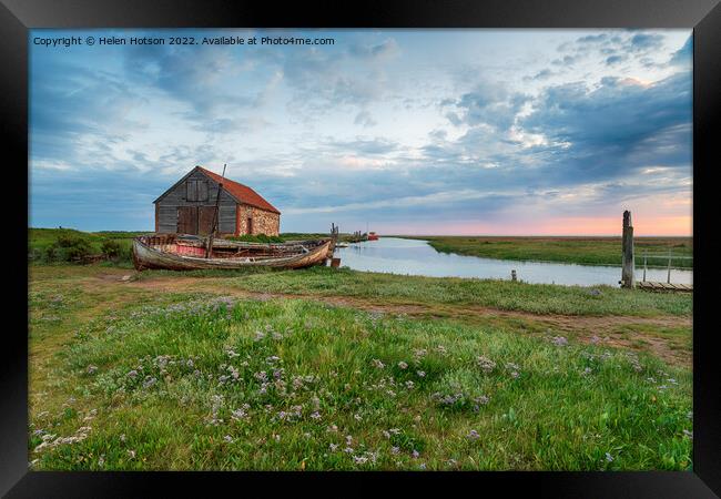 Dramatic sunrise sky over the old coal barn at Thornham Framed Print by Helen Hotson