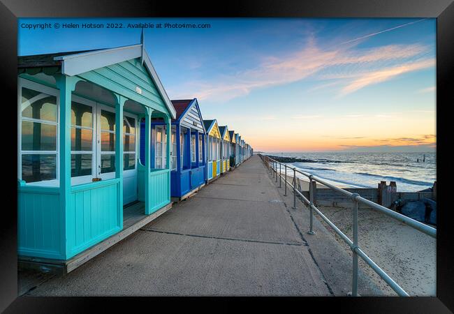 A row of colorful beach huts at Southwold Framed Print by Helen Hotson