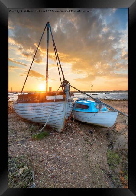 Stunning sunset over old fishing boats on the shore at West Mers Framed Print by Helen Hotson