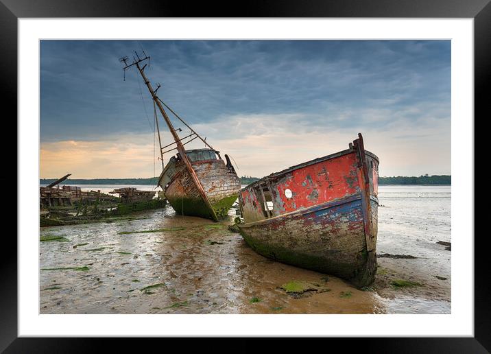 Old boat wrecks under a stormy sky Framed Mounted Print by Helen Hotson