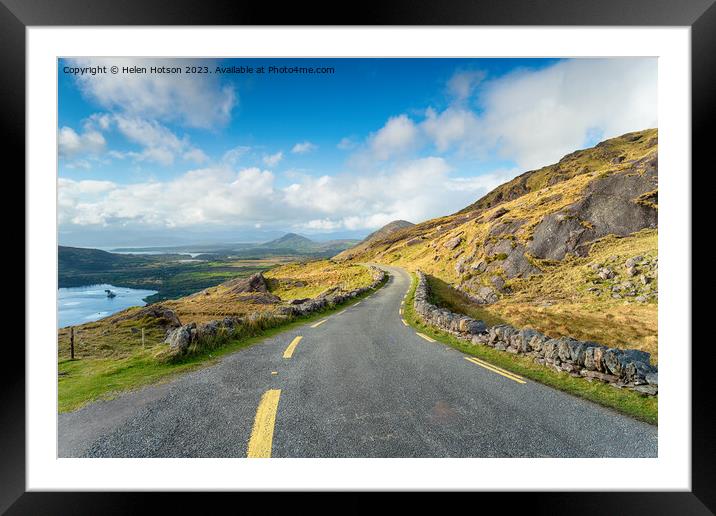 The single track road winding through the Healy Pass Framed Mounted Print by Helen Hotson
