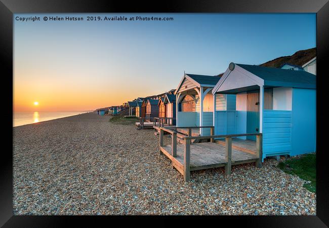 Sunset over Beach Huts Framed Print by Helen Hotson