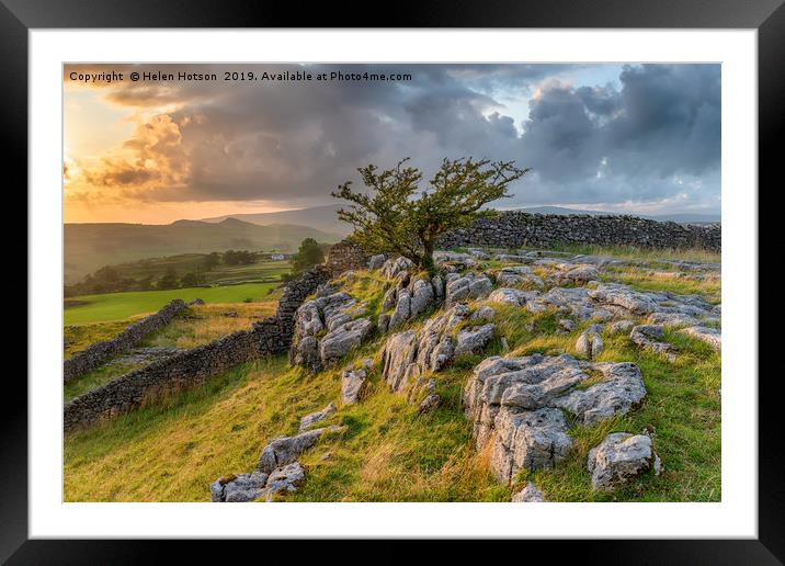 Stormy sunset over a small limestone pavement Framed Mounted Print by Helen Hotson